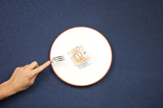 hand of man and wad of euros on white plate