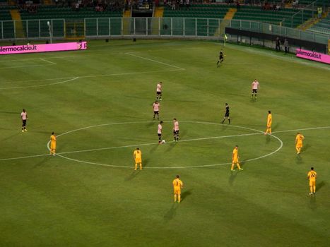 The two teams placed in the center circle at the time of kick-off during the TIM Cup match between US Citta di Palermo and Hellas Verona at Stadio Renzo Barbera on August 17, 2013 in Palermo, Italy.