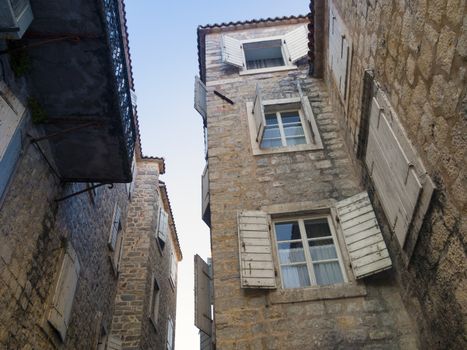 narrow space between ancient buildings in Old City of Budva, Montenegro