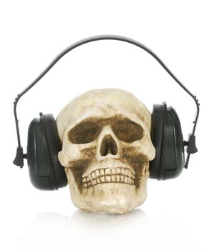 hearing damage - skull wearing protective ear headphones on white background