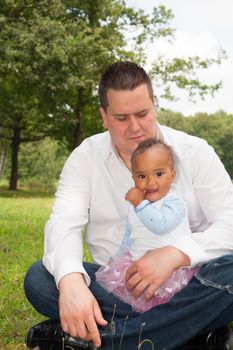 Happy mixed family is having a nice day in the park