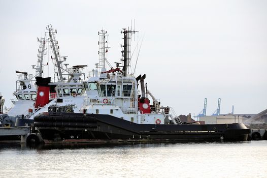 Tug boats with quay for the evening in a creek of Fos on Sea beside Marseille.