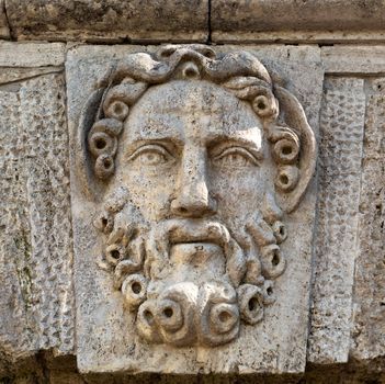 sculpture in stone face with a beard close-up