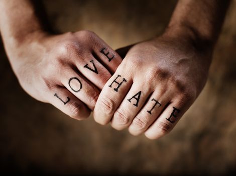 Man with (fake) Love and Hate knuckle tattoos.