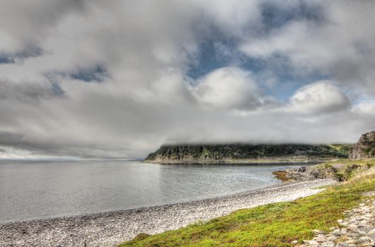 Norwegian fjord and mountains in cloudy weather