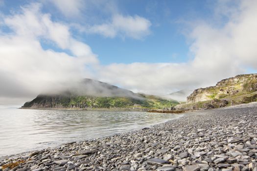 Norwegian fjord and mountains in cloudy weather