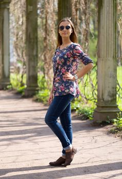 beautiful young woman in full length in the ancient columns