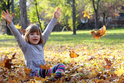 beautiful little girl in autumn park