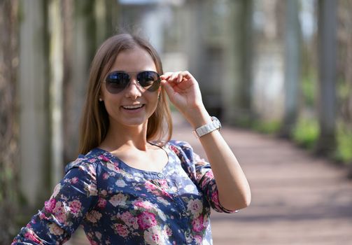 portrait of a girl in sunglasses on the background of the ruins