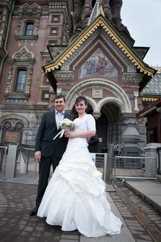 bride and groom near the temple