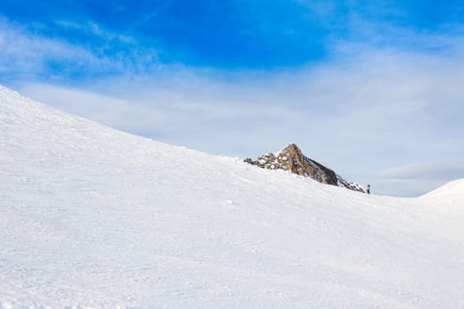 winter with ski slopes of kaprun resort next to kitzsteinhorn peak in austrian alps