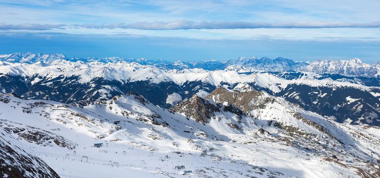 winter with ski slopes of kaprun resort next to kitzsteinhorn peak in austrian alps