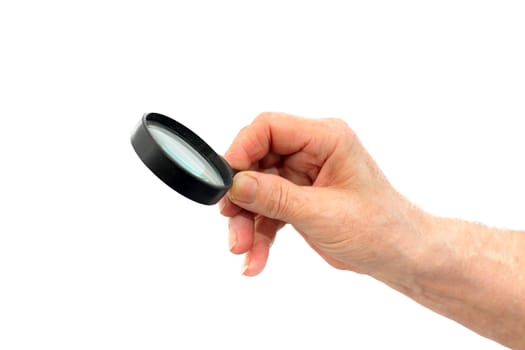 senior hand with loupe on the white background