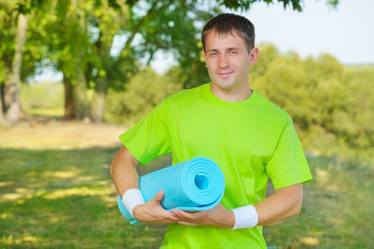 a sportsman holding yoga mat