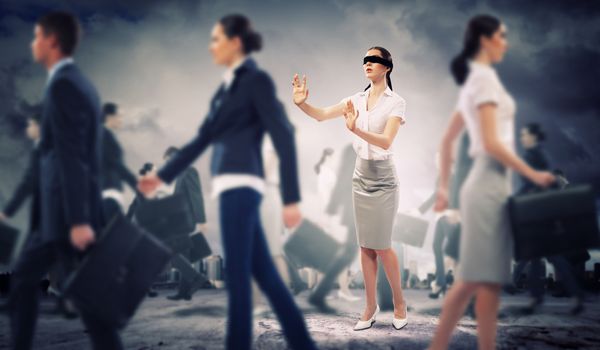 Image of businesswoman in blindfold walking among group of people