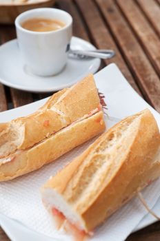 Bocadillo breakfast on the wooden table with coffee