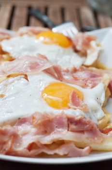 Breakfast with bacon and eggs on the wooden table