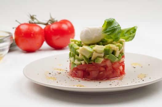 Salad with avocado and tomatoes on the plate