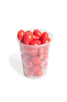 Cherry tomatoes in plastic glass on white