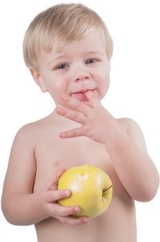 Little cute boy eating apple in studio