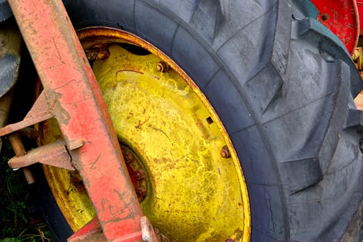 Close details of an old abandoned rusty tractor in a farm