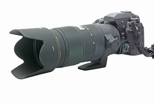 Modern DSLR camera with zoom lens attached on white