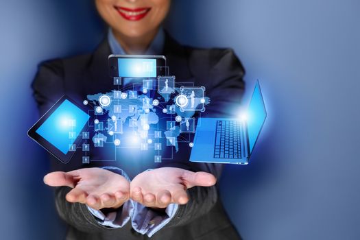 Close up image of businesswoman with 3d images of devices in her hands