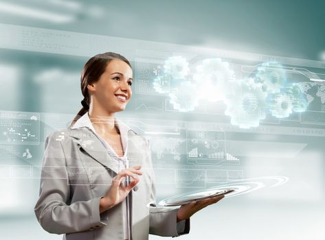 Image of businesswoman with tablet pc against high-tech background