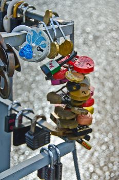 Padlocks locked by lovers, onto a framework on a bridge, as a token of love and dedication to each other