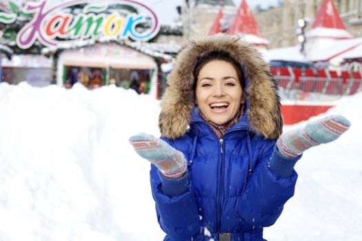 Portrait of a young woman on the background of a winter city