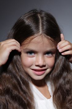 close up portrait of young beautiful little girl with dark hair