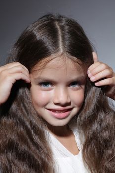 close up portrait of young beautiful little girl with dark hair