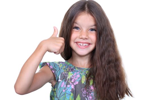 Beautiful little girl shows finger as sign that everything is fine