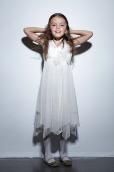 portrait of pretty little girl in white dress
