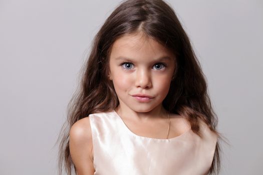 close-up portrait of a little amazing girl with blue eyes and opening mouth isolated on white