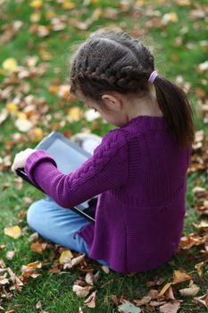 Little Girl holding tablet digital computer