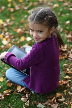 Little Girl holding tablet digital computer