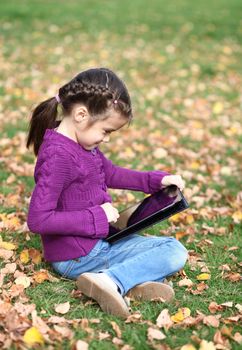 Little Girl holding tablet digital computer