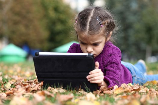 Little Girl holding tablet digital computer