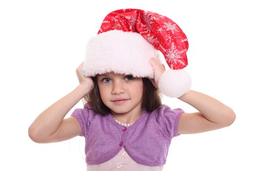 Portrait of happy little girl in Santa hat isolated on white background