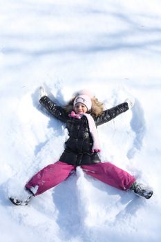 Beautiful little girl in winter park