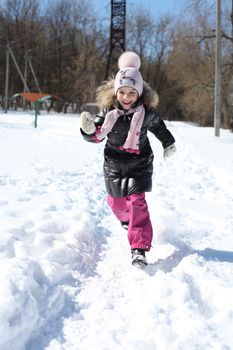 Beautiful little girl in winter park