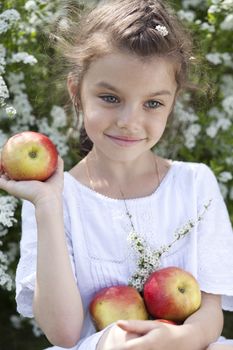 Portrait of beautiful little girl in spring blossom