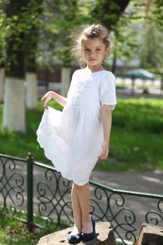 Portrait of beautiful little girl in spring park