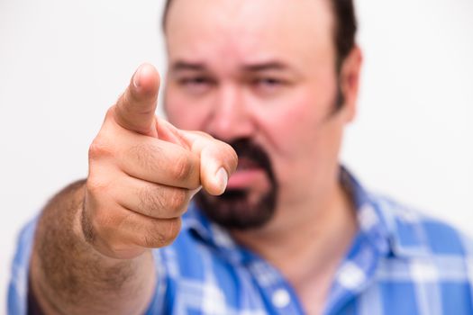 Man pointing an accusatory finger at the camera as he singles out someone to take the blame with selective focus to the hand