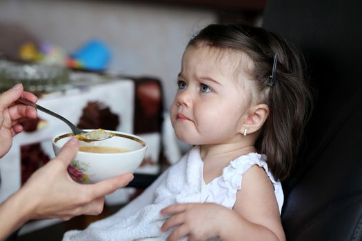 Little baby girl eating soup