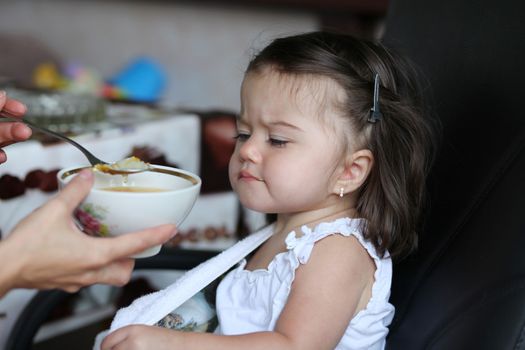 Little baby girl eating soup