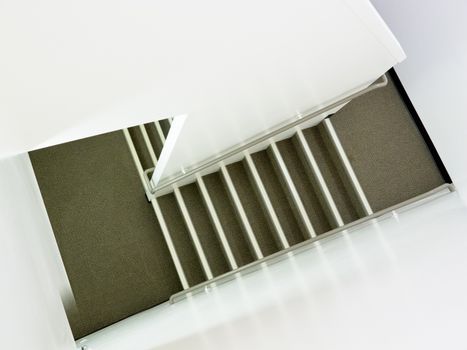 Staircase inside modern residential apartment building in high-angle view as an architectural abstract background.