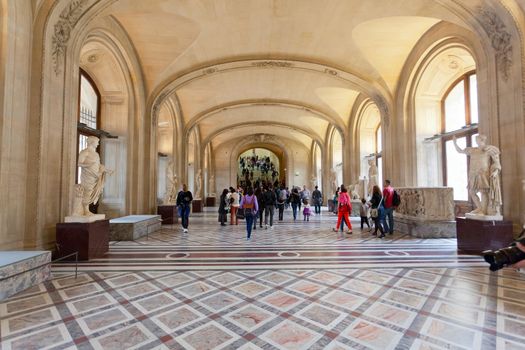 Visitors in painting gallery on October 3, 2012 in Louvre Museum, Paris, France. With 8,5m annual visitors, Louvre is the most visited museum worldwide