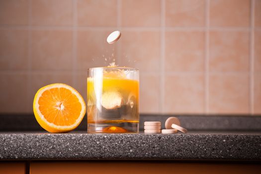 Vitamin C healthy lifestyle concept – orange, tablet stack, dissolving tablet 